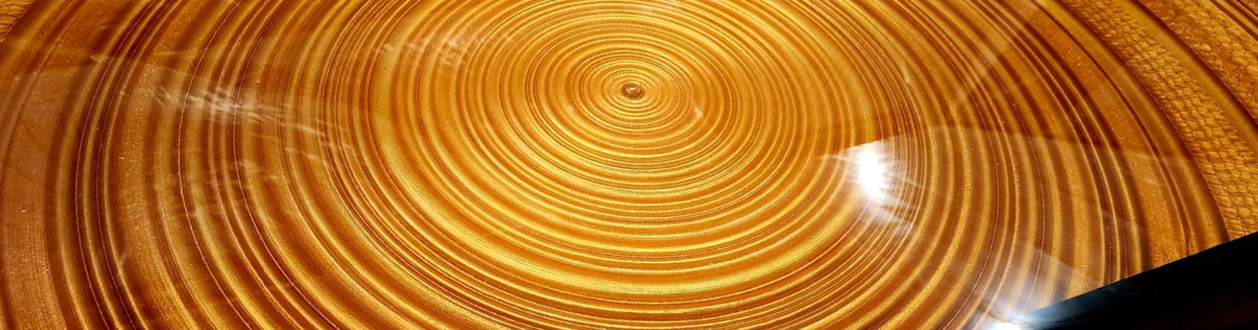 Glossy wood tabletop with concentric ring patterns